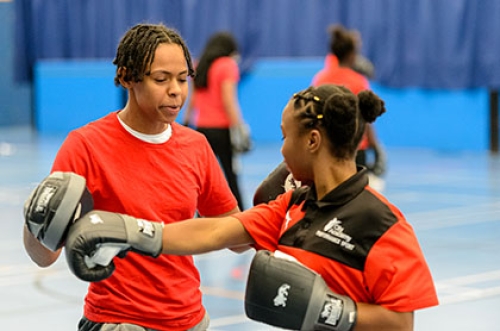 Two school children in a boxing drill during a school PE lesson